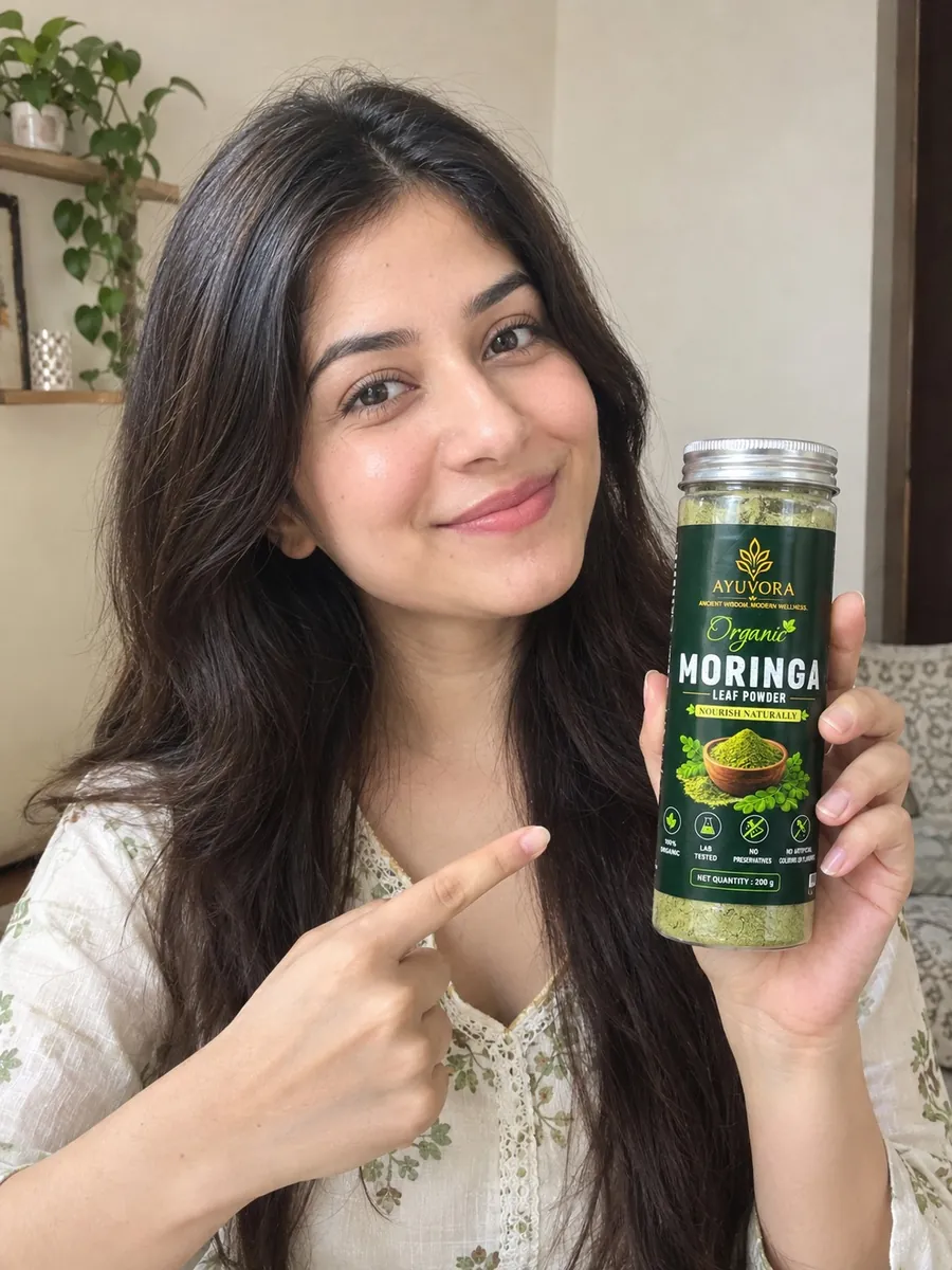 Woman holding a jar of Ayuvora Organic Moringa Leaf Powder